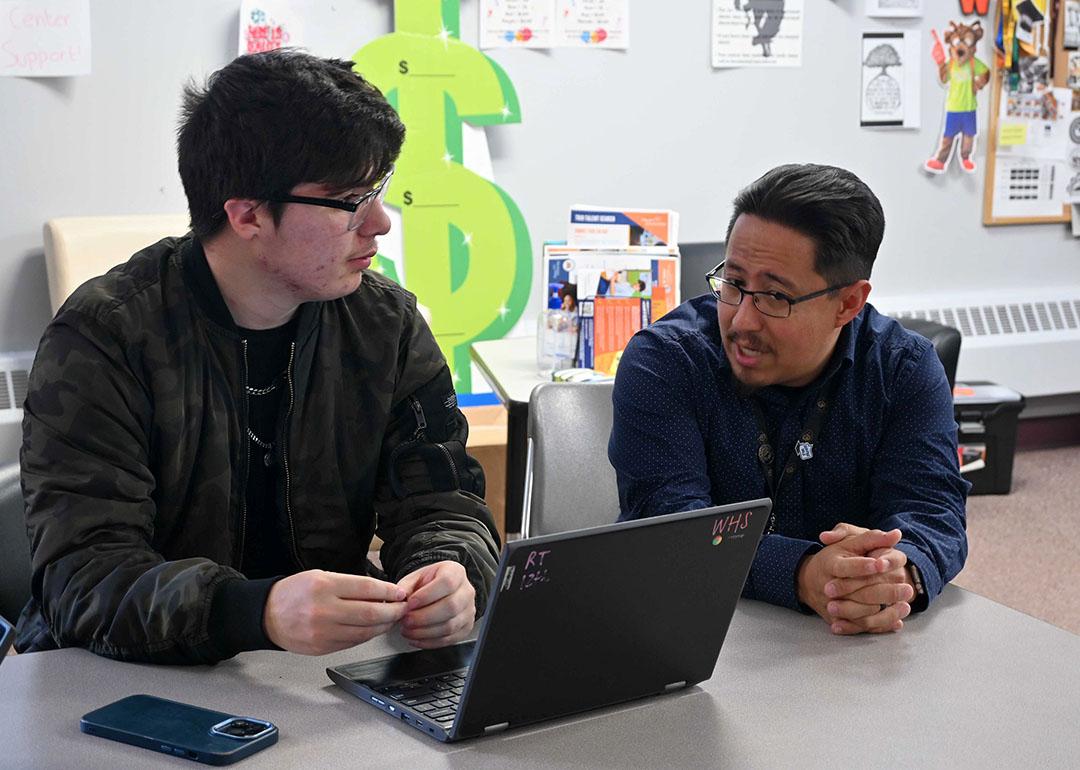 Rene Torres, left, works on his FAFSA with Denver Scholarship Foundation college adviser Federico Rangel at Denver's West High School in April.