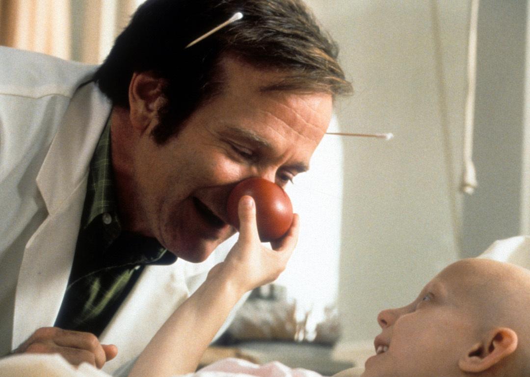 Robin Williams visits a sick child in a scene from the film 'Patch Adams', 1998.