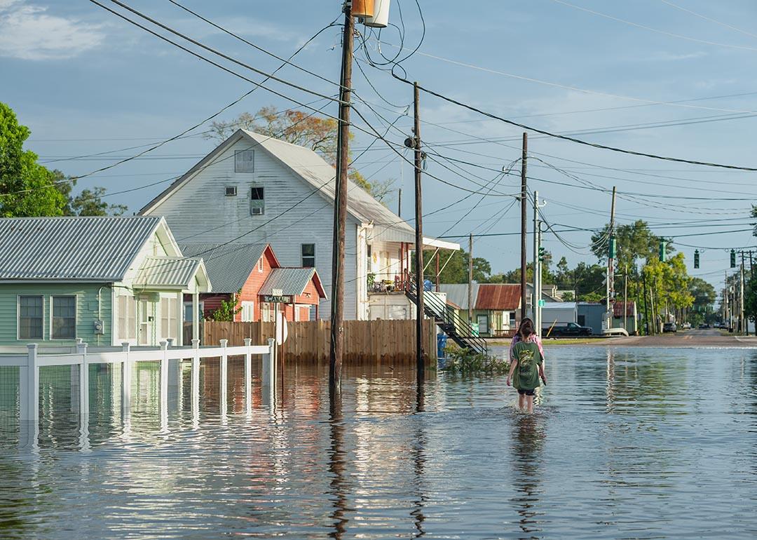 Person walking on flooded Canal street in Delcambre in Louisiana during Hurricane Laura.