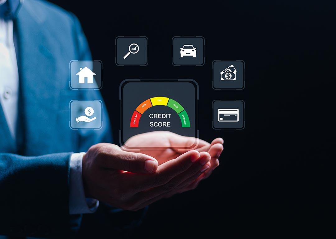 Holographic icons showing what a credit score can access hovers a person's hands.