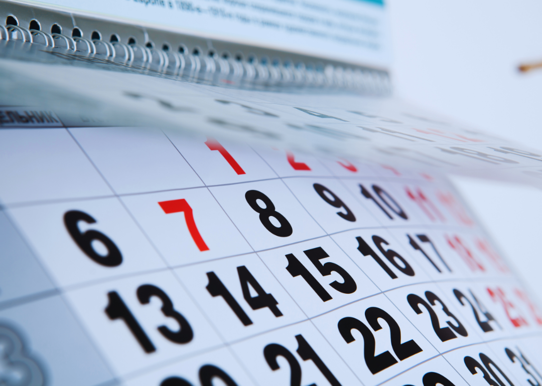 A calendar with red and black dates.