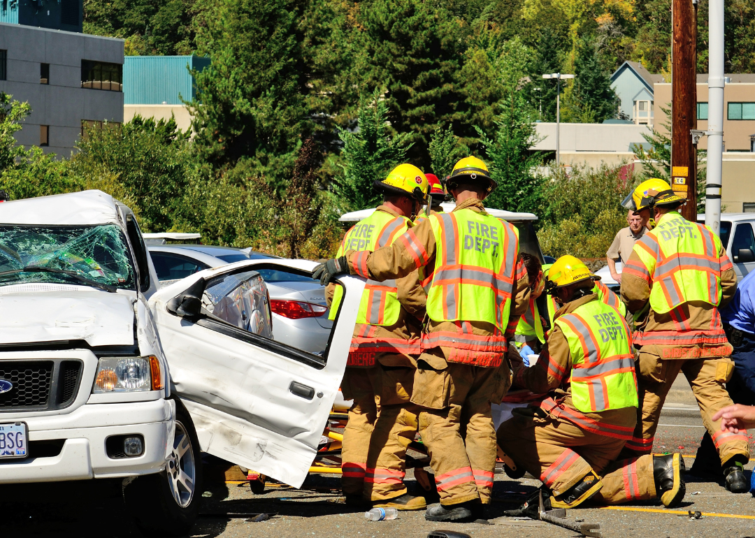 Firefighters extricate victims of a two vehicle t-bone accident at an intersection