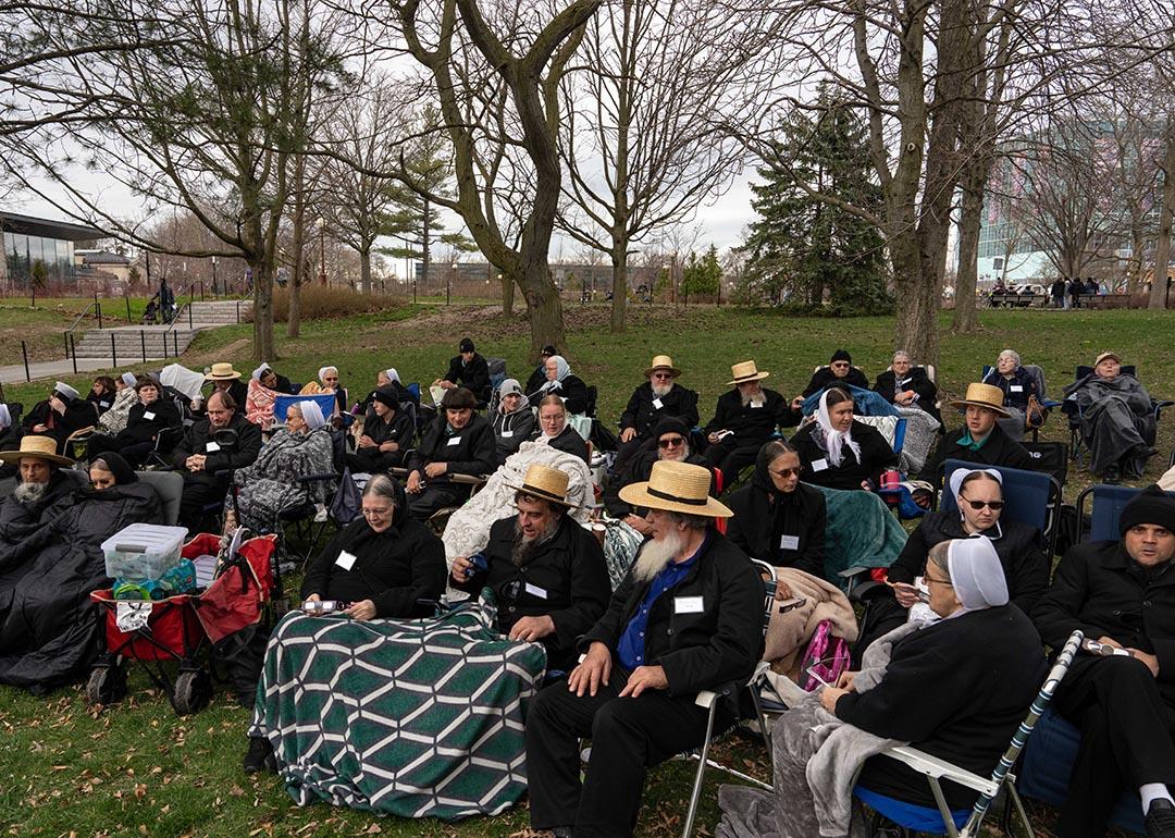 Members of the Amish community sit to watch the Solar Eclipse on April 8, 2024 in Niagara Falls, New York.