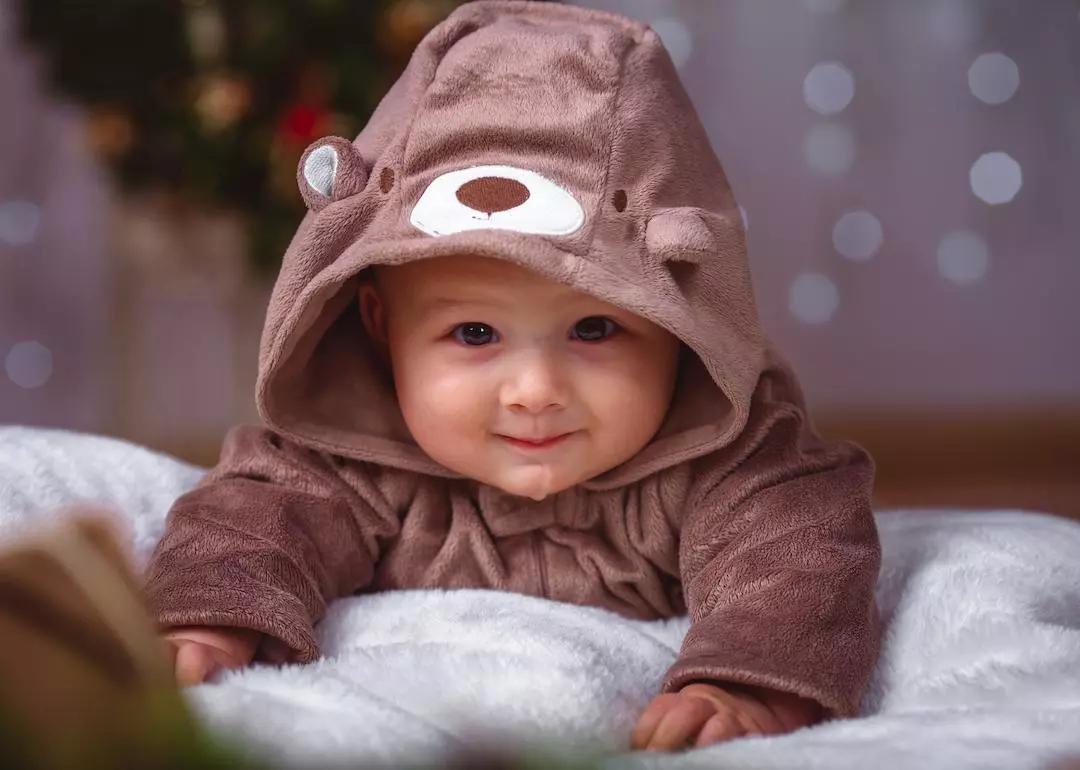 Happy infant in baby bear robe.