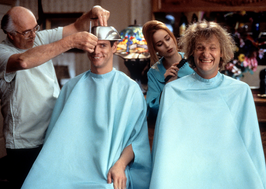 Jim Carrey and Jeff Daniels getting their hair cut in a scene from the film 'Dumb & Dumber', 1994. 