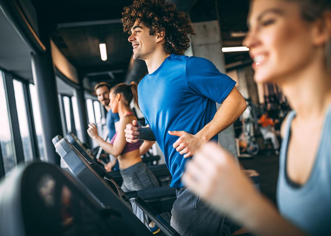 People running on treadmills at a health club.