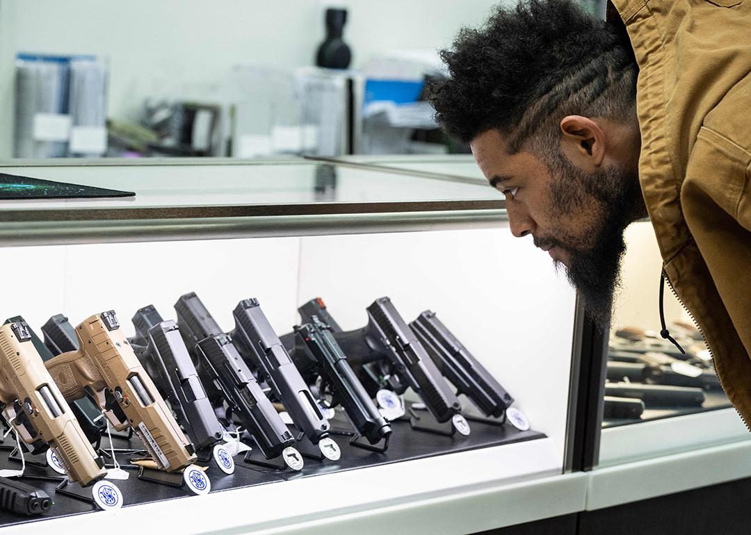 Jordan Landis, a gun collector, looks at guns in EJB's Gun Shop in Capitol Heights, Maryland.