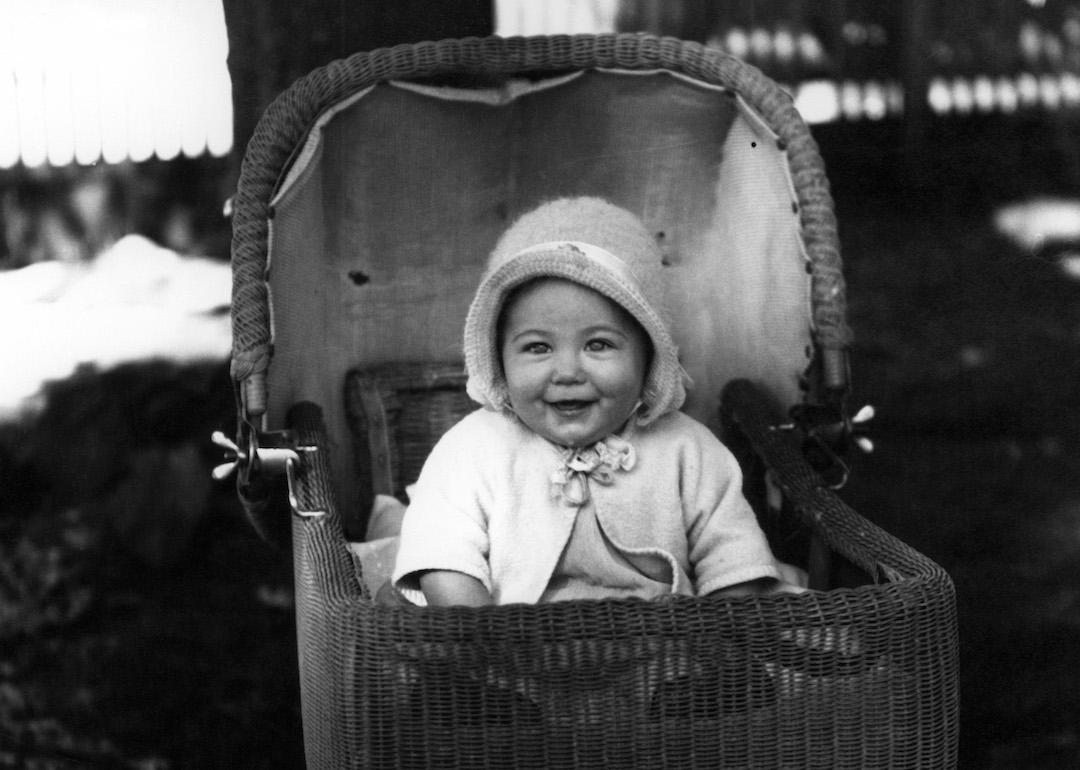 Happy baby in a buggy in the late 1930s.