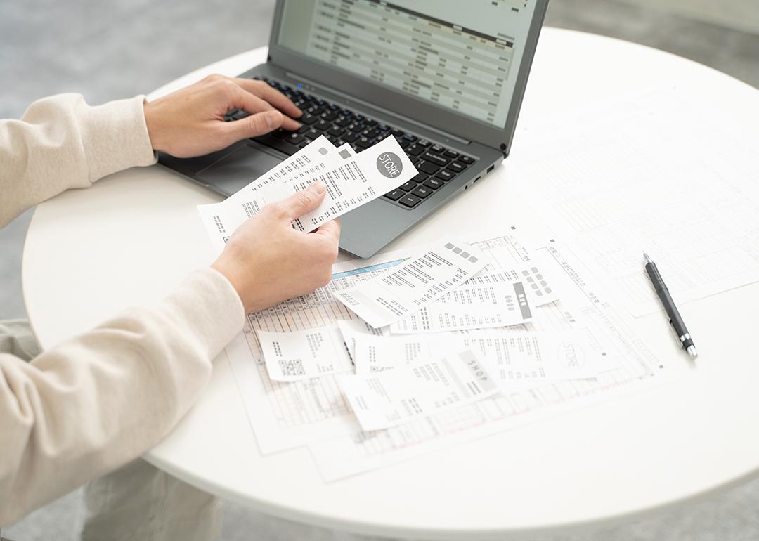 Business person entering receipt information in an expense software.