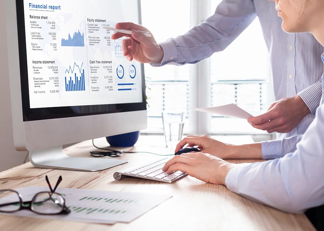 Businessmen using a finance management software for reporting.