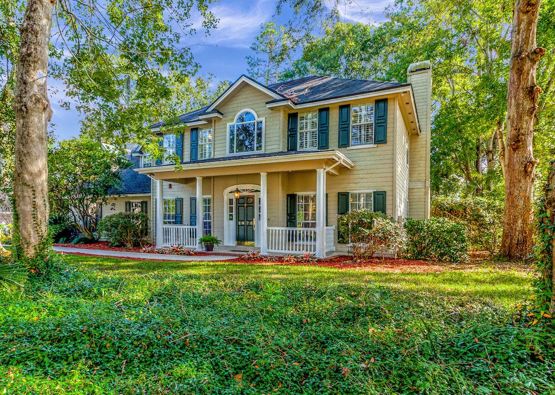 Two story home surrounded by trees in Fleming Island, Florida.