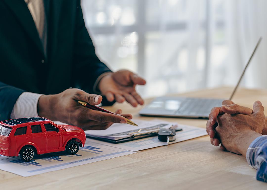 A car insurance transaction between a salesman and customer.