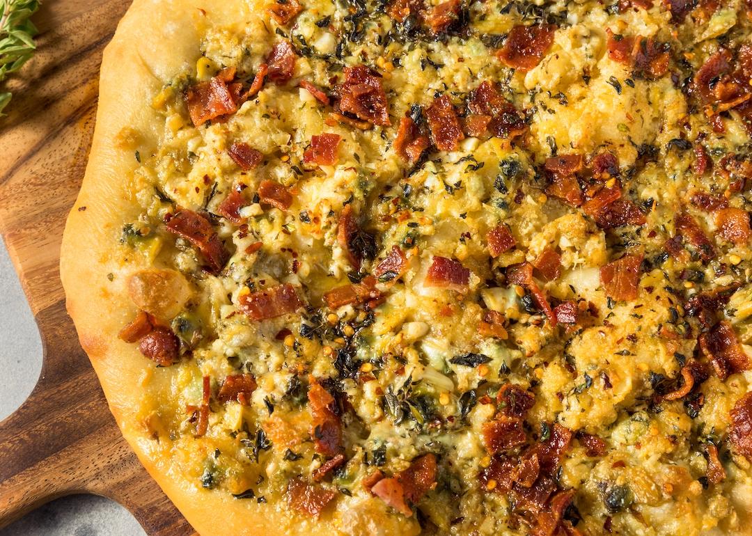 Homemade New Haven clam white pizza with oregano and bacon.