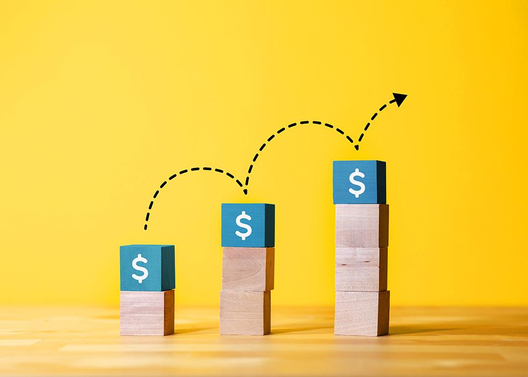 Concept of investment growth represented by an increasing stack of cubes with dollar signs.