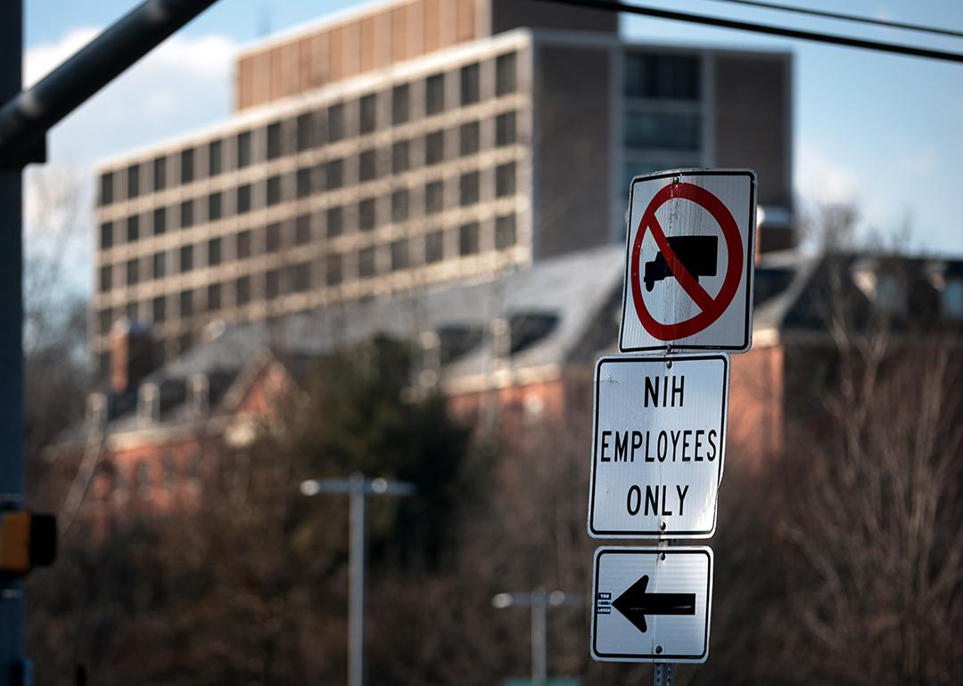 A sign that reads "NIH Employees Only" near an entrance at the National Institute of Health in Bethesda, Maryland.