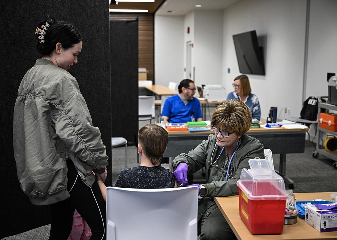A medical staff member administers a dose of the measles vaccine to a child at a health center in Lubbock, Texas.