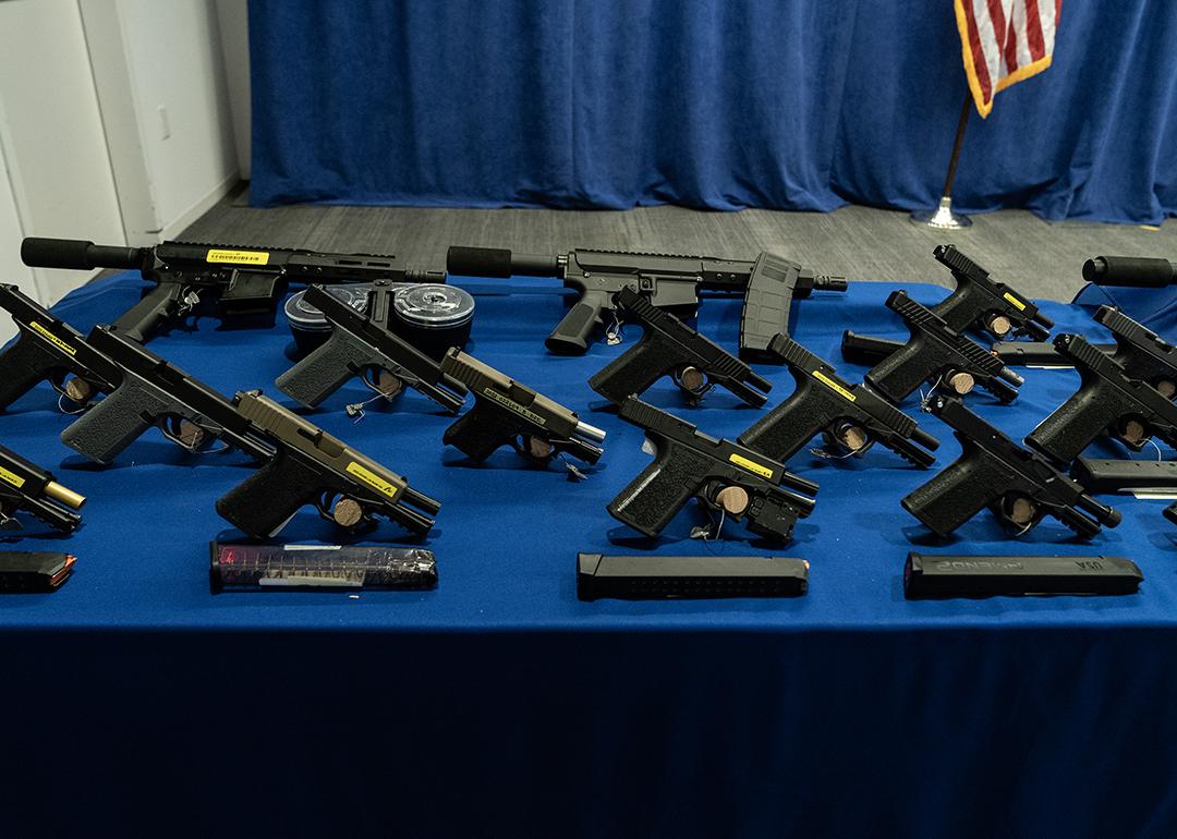 Confiscated guns on display at a press conference.