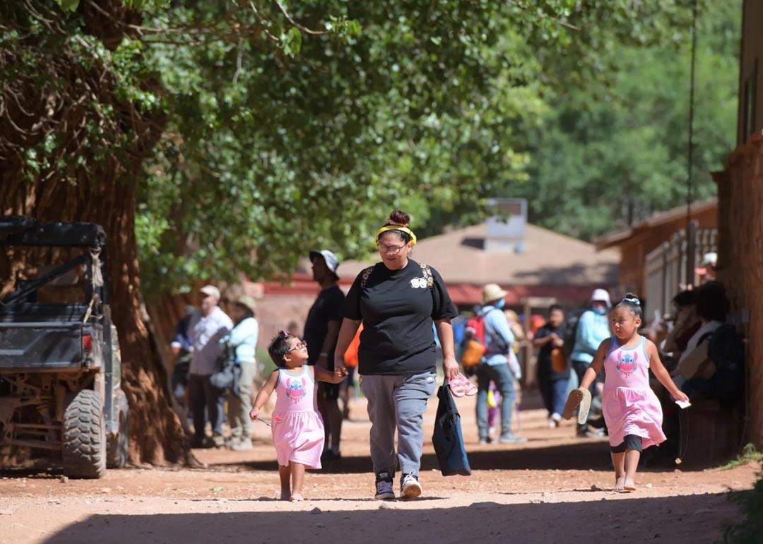 Winona Hastings and her daughters walk through the village of Supai on their way to the Havasupai Head Start and Early Start Program. 