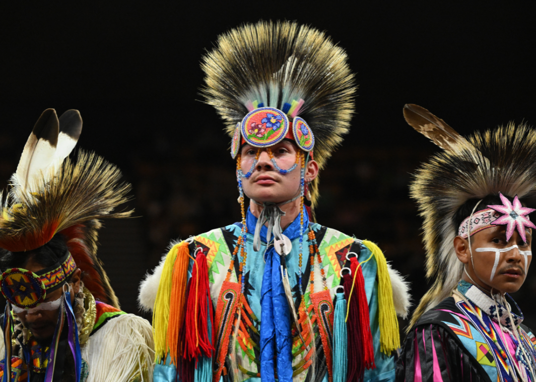 Men dressed in traditional Native American wear wait to hear the results after competing in the grass dance during the 48th annual Denver March Pow Wow at the Denver Coliseum in Denver, Colorado on March 17, 2024.