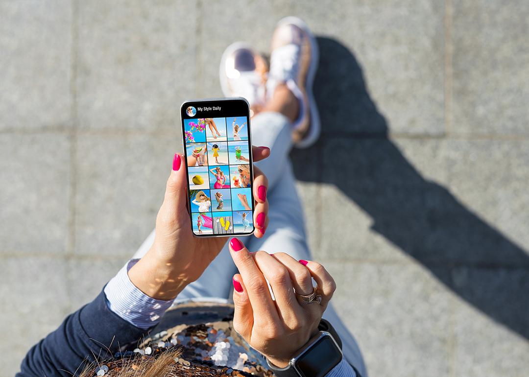 A woman viewing a lifestyle profile's page and photo feed.
