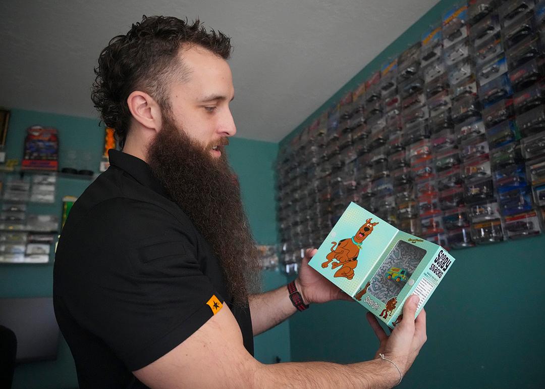 Ian Weber holding a scooby doo van from his Hot Wheel collection.