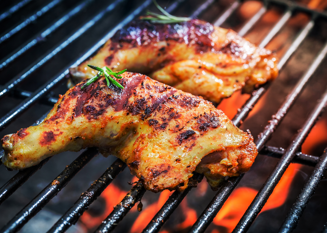 Roasted chicken legs on a hot grill