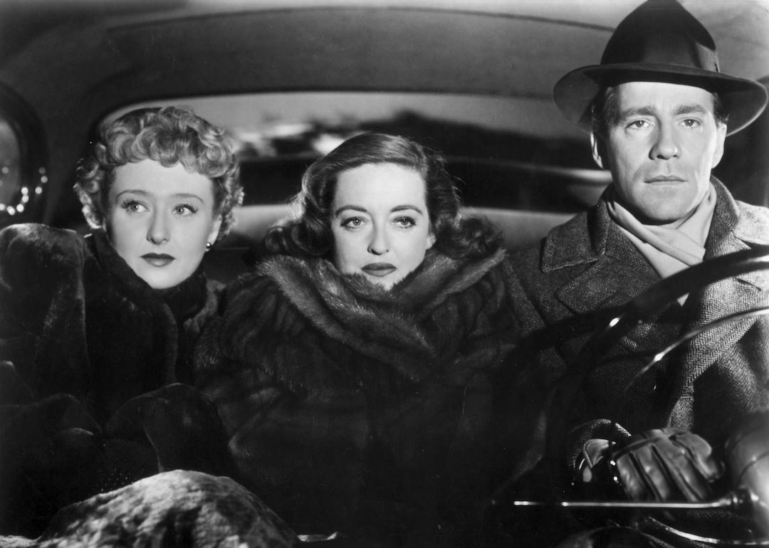 Celeste Holm, Bette Davis, and Hugh Marlowe take a bumpy car ride together in the 1950 film 'All About Eve.'