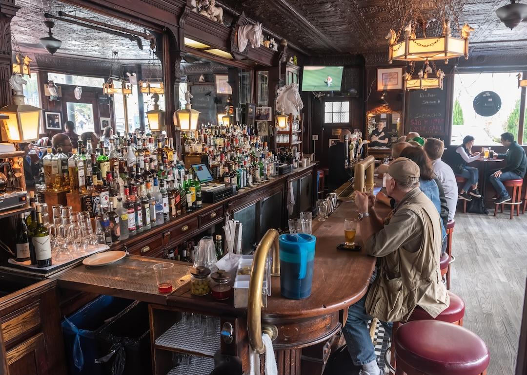 Patrons sitting at bar counter at the White Horse Tavern in New York City.