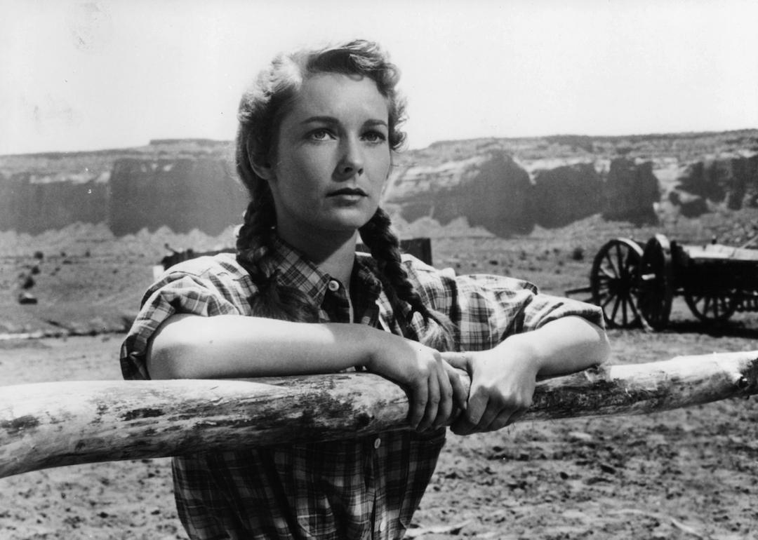 Vera Miles holds onto a wooden fence in a scene from the 1956 film 'The Searchers.'