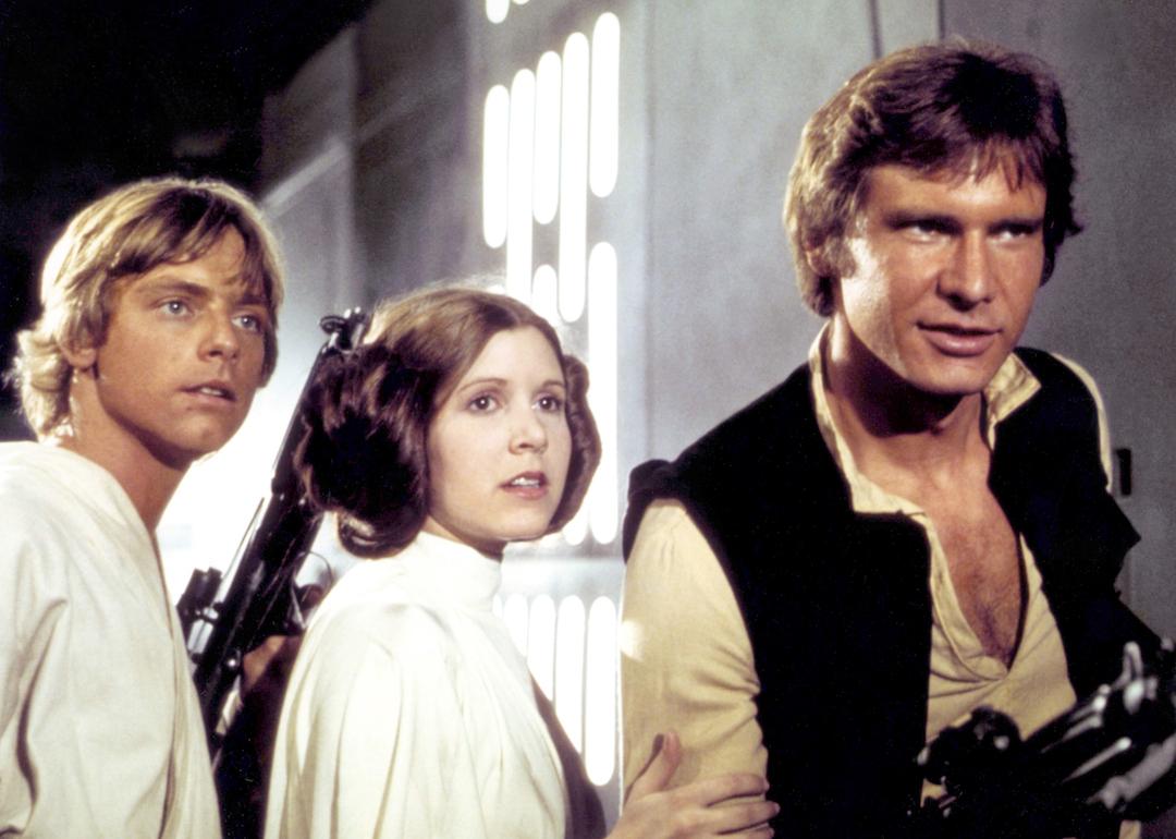 Actors Mark Hamill, Carrie Fisher, and Harrison Ford in the 1977 movie 'Star Wars: Episode IV - A New Hope.'