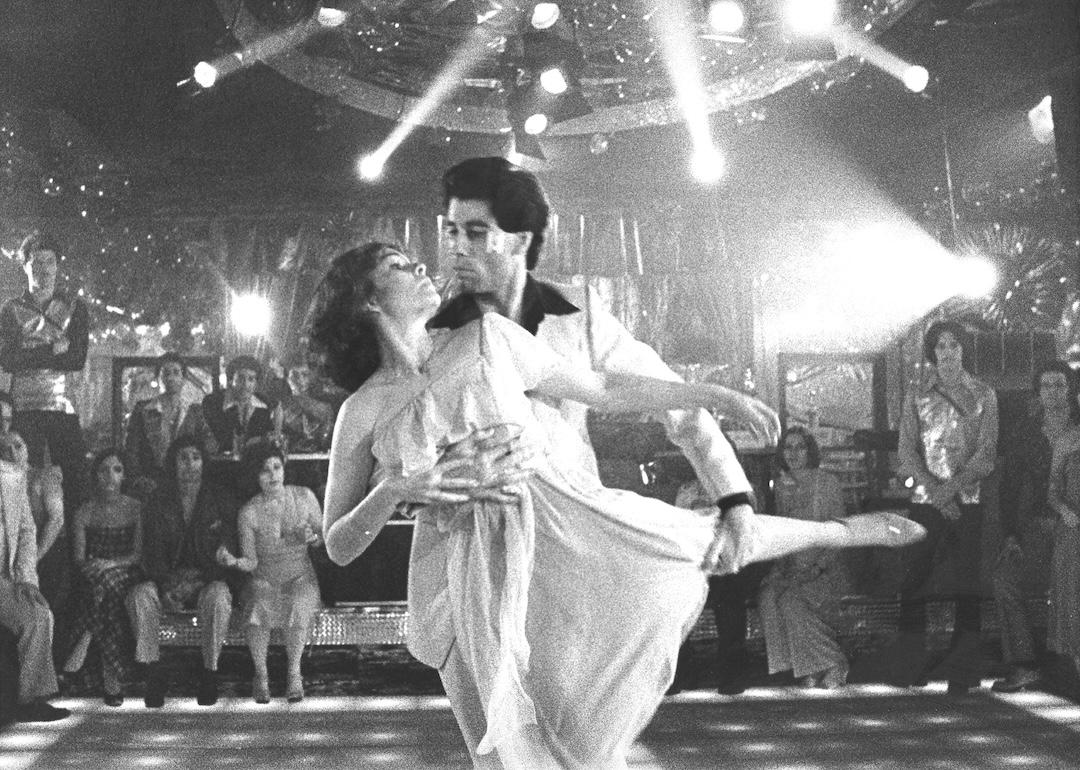 John Travolta dances with Karen Lynn Gorney in a scene from Saturday Night Fever, directed by John Badham.