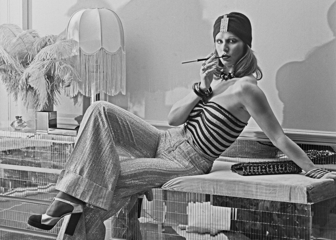 A model wearing wide-legged trousers, a striped tube top and a turban-style hat at the Biba boutique in London, UK, 6th September 1973.
