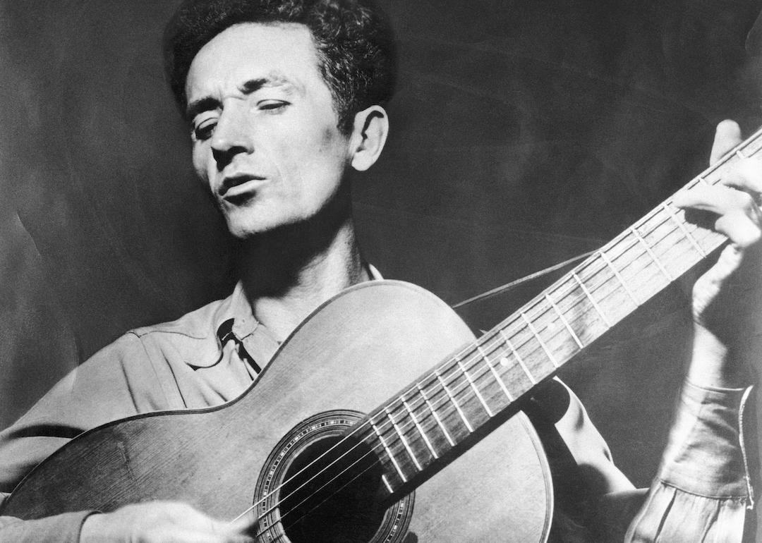 Woody Guthrie playing the guitar.