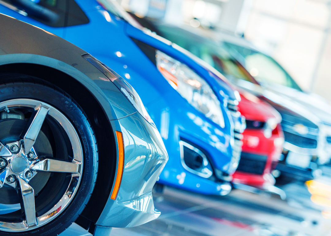 New cars are lined up for display in a showroom.
