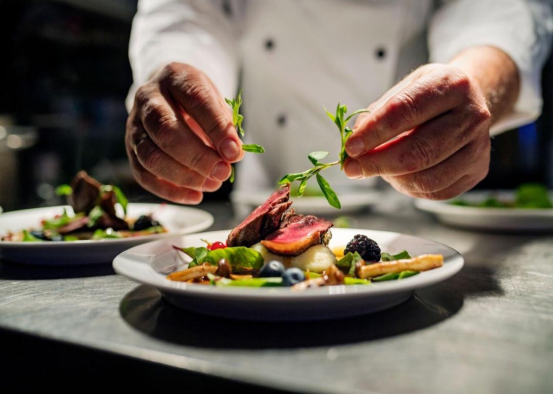 A chef plating a colorful dish.