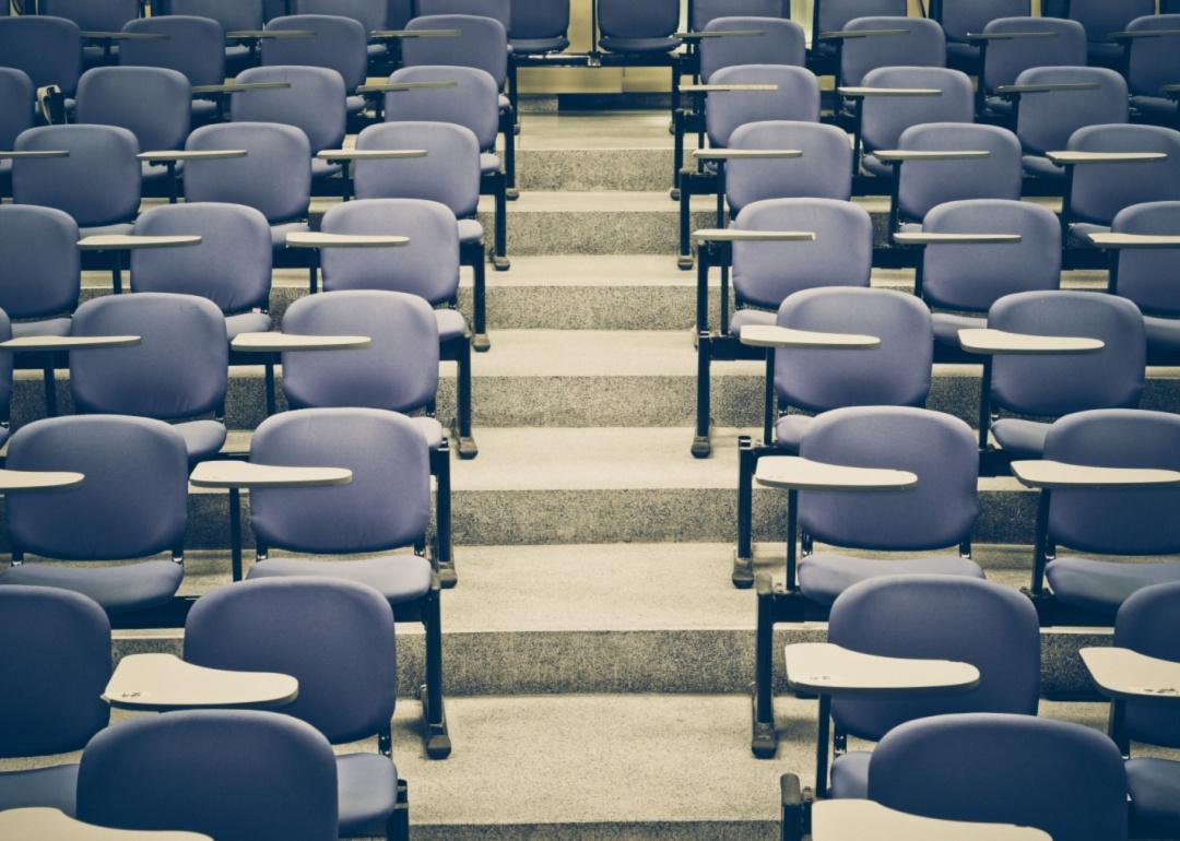 Empty blue seats in a lecture room.