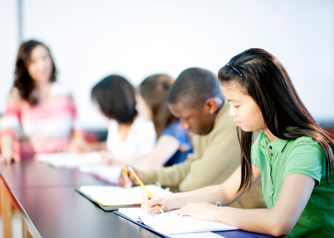 Students in a row taking a test.