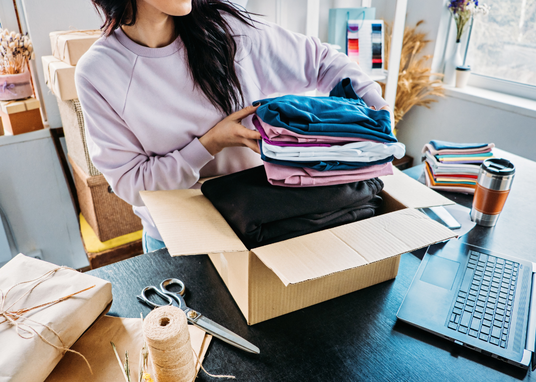 A woman fills a package for her small, e-commerce business
