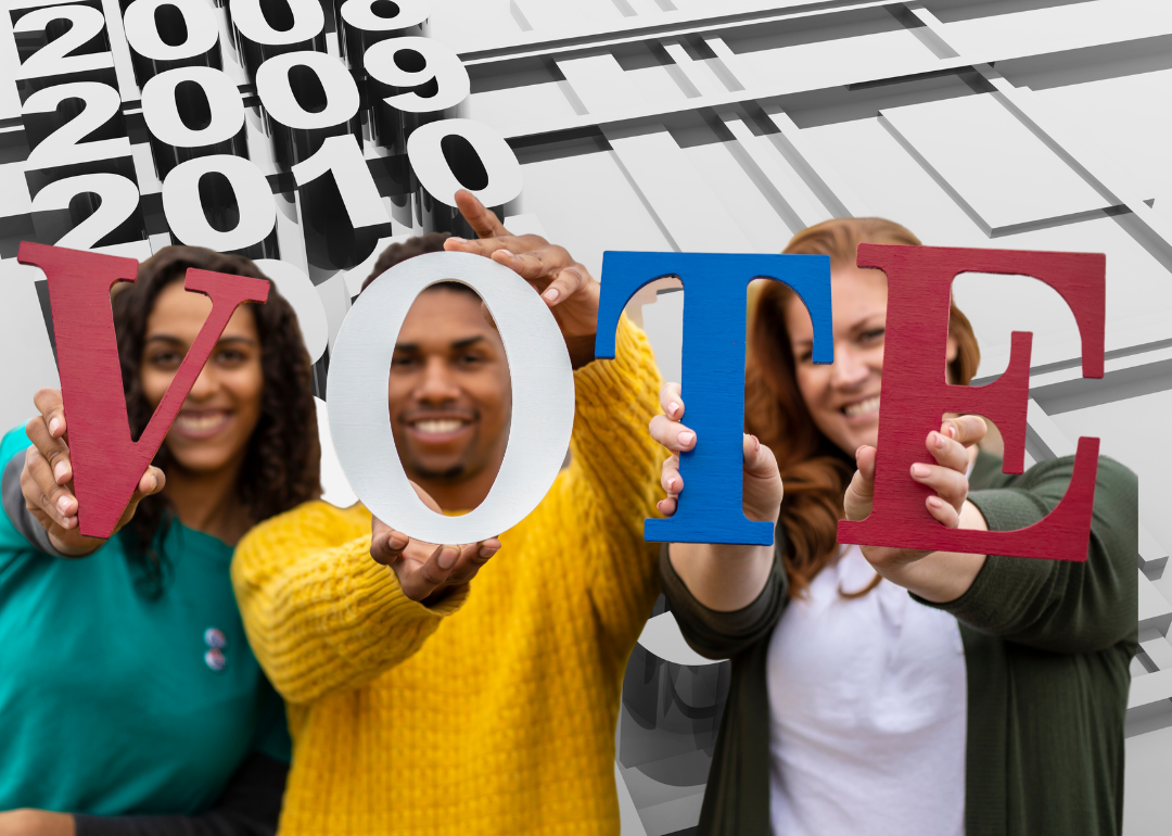 People hold up letters spelling out VOTE.