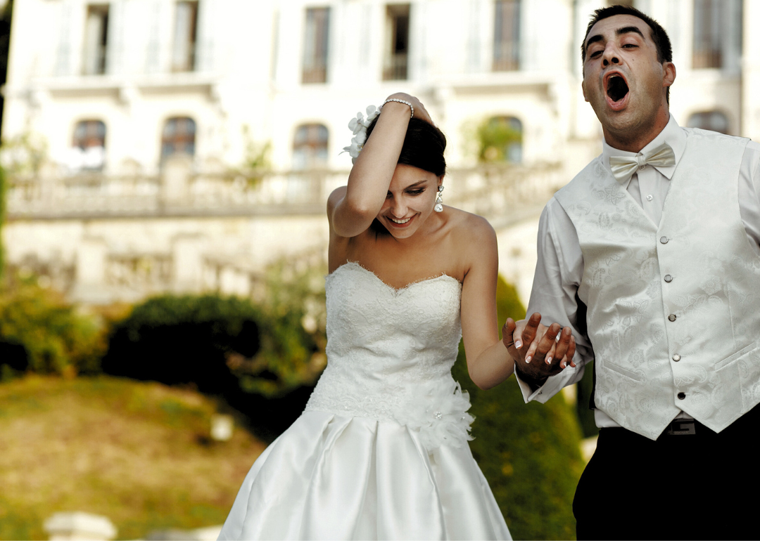 A couple at their wedding looking happy.