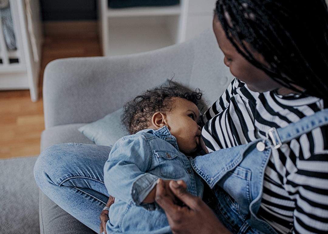 A mother breastfeeds a baby.