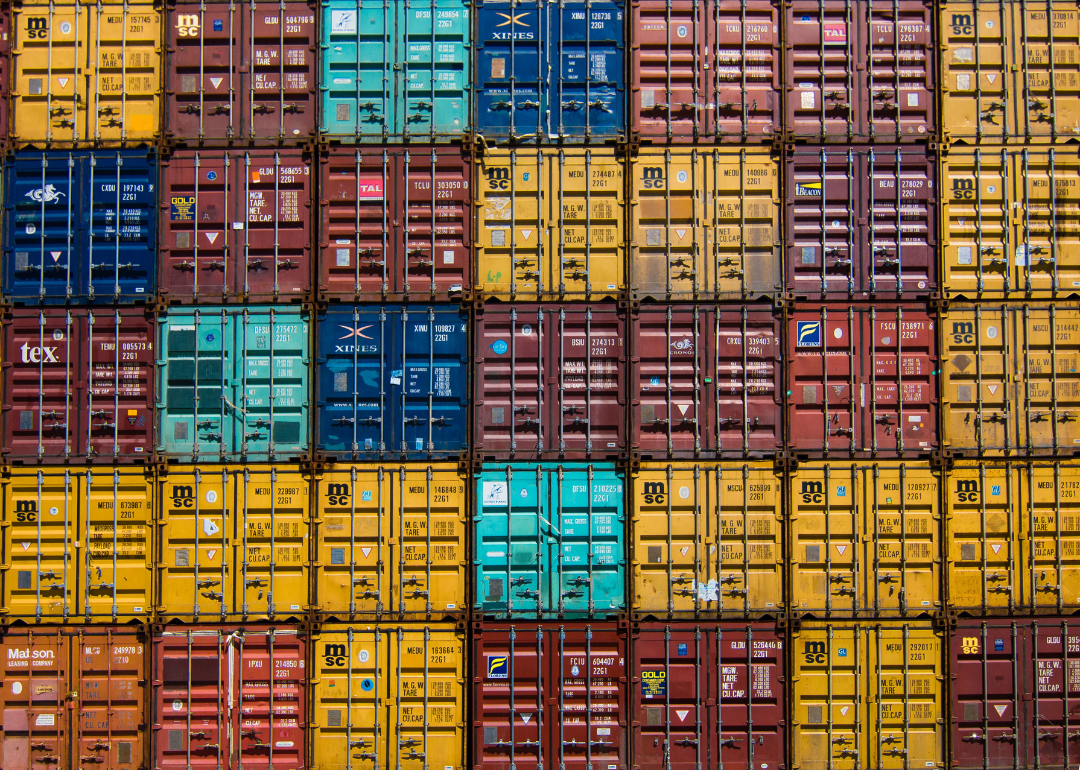 Stacks of different colored shipping containers.