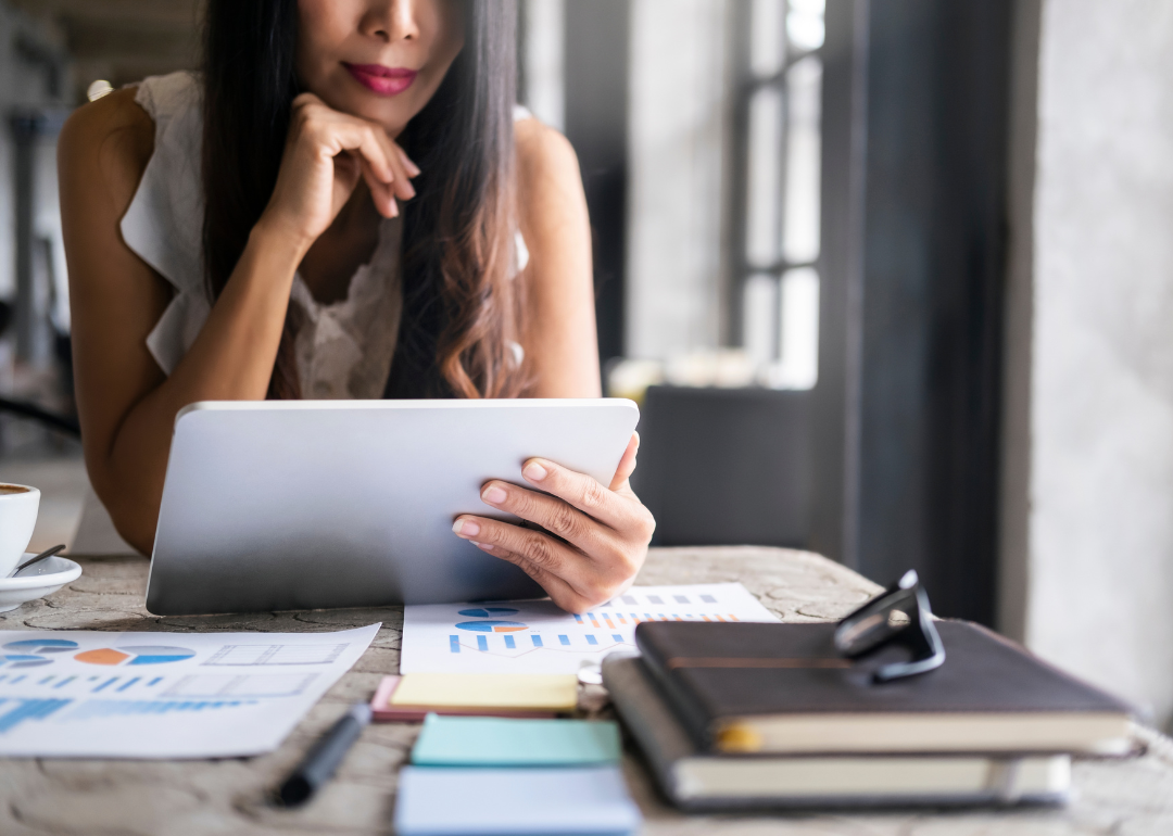 Woman looking at tablet and research.