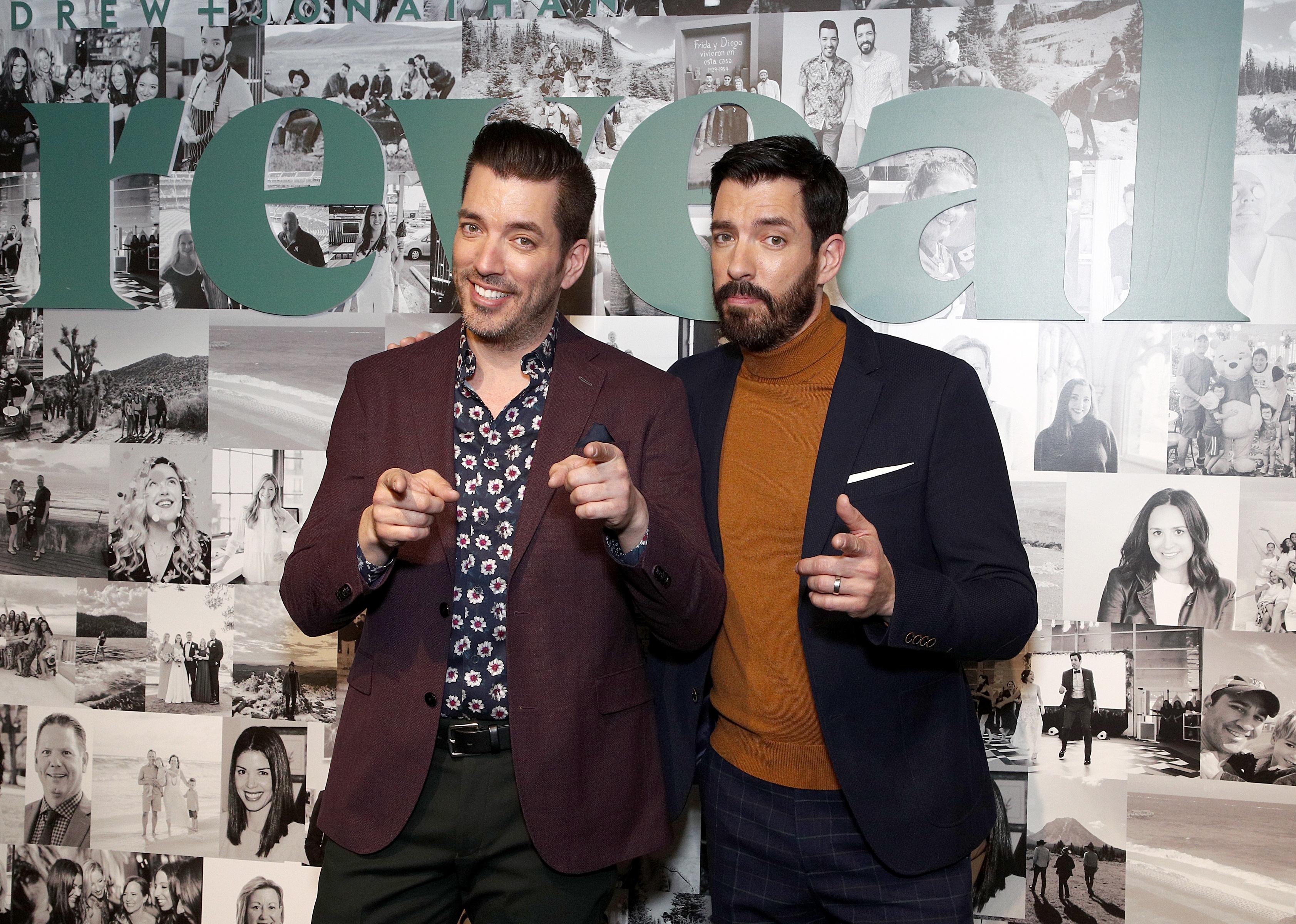Jonathan Scott and Drew Scott pose during a premier reveal.
