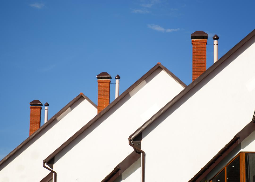 Front view of houses on a background of blue sky.