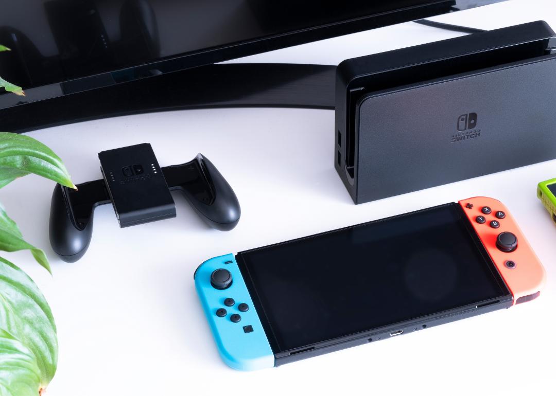 Nintendo Switch video game console next to the TV in a home living room.