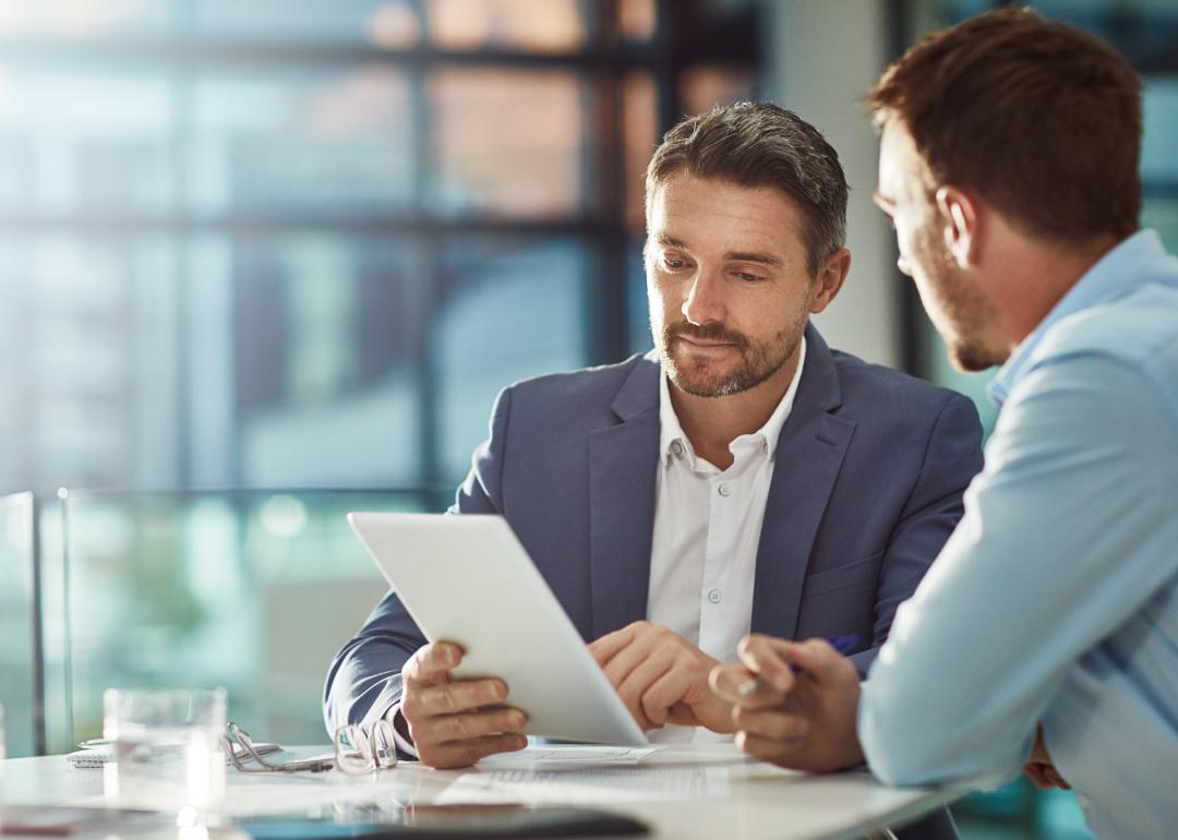 Two coworkers looking at a tablet.