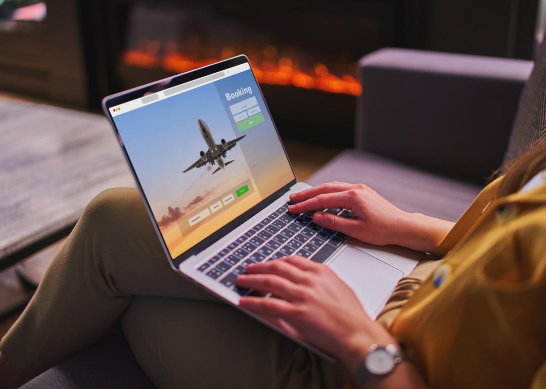 A woman booking plane tickets using computer.