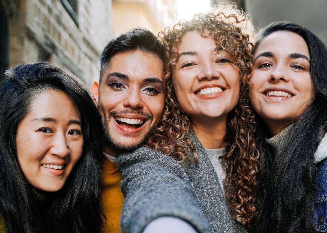 Diverse group of friends taking selfie outdoors.
