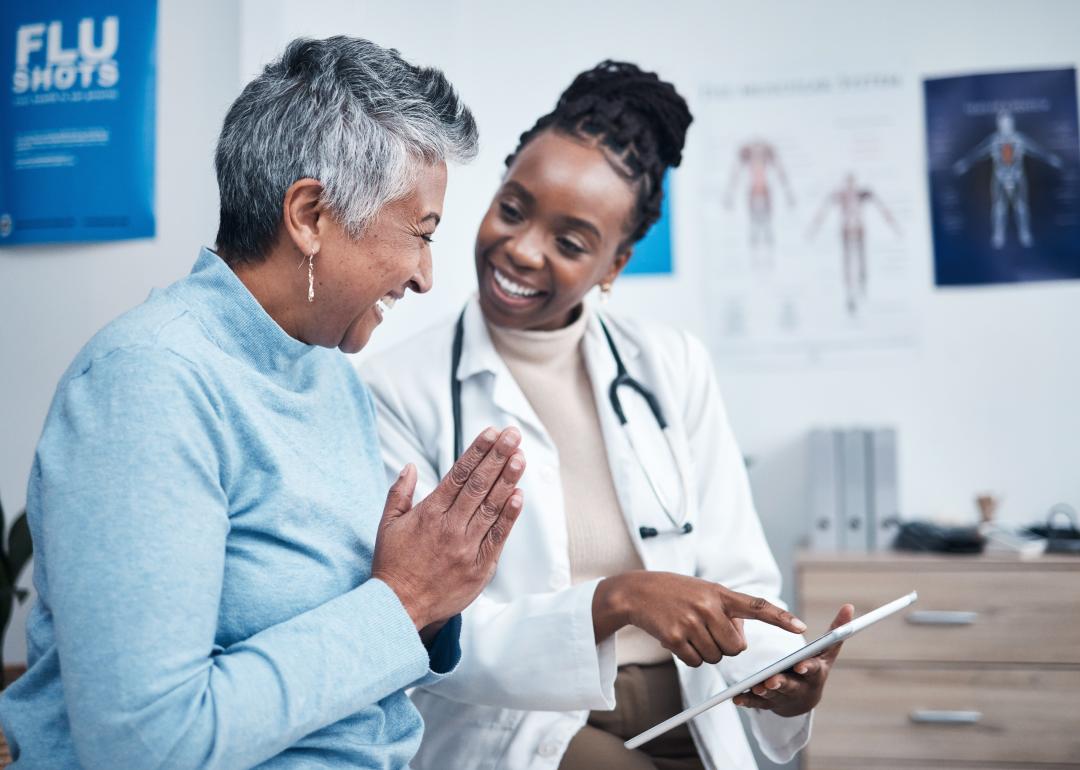 Doctor and elderly patient with a tablet.